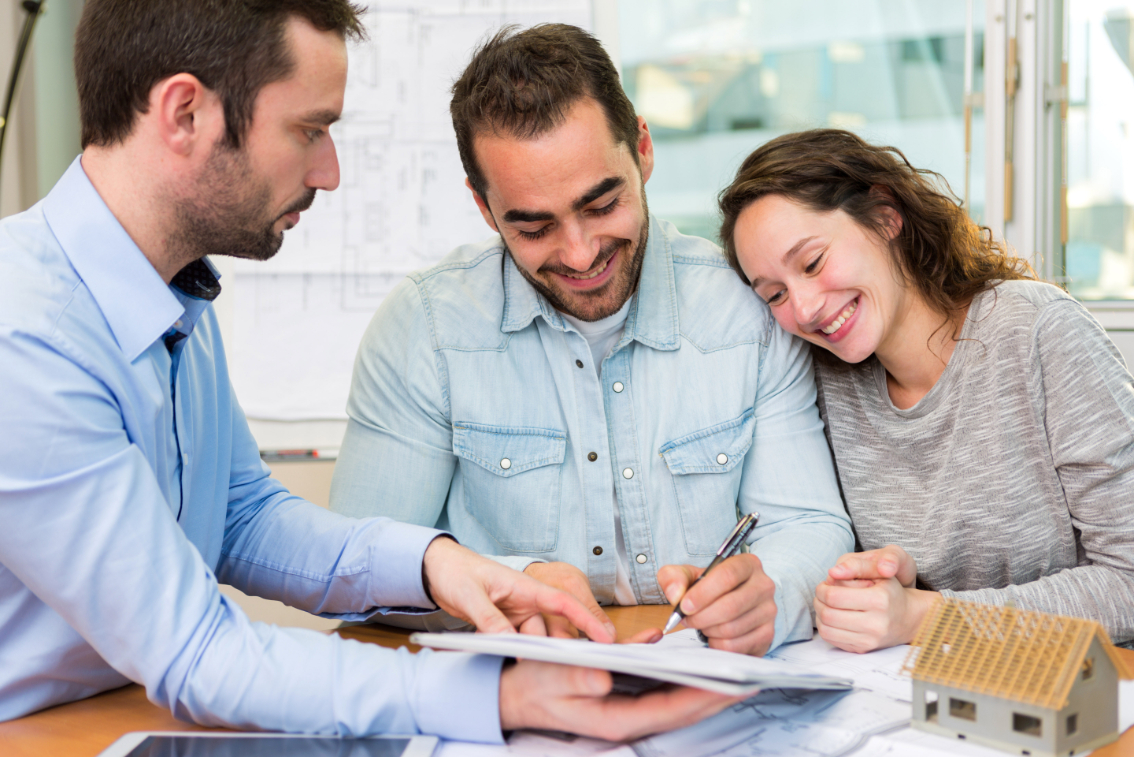 Young attractive couple signing contract